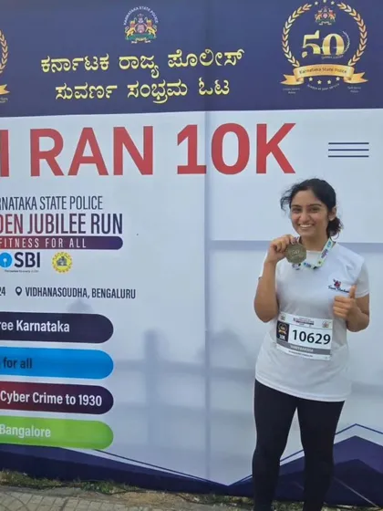 Posing with her medal, this team member shows the pride of finishing a challenging race.