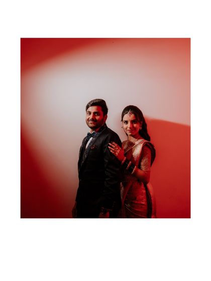 A stylish reception portrait using bold red lighting to create a dramatic and modern feel. We love playing with light and color to match the mood of your celebration.