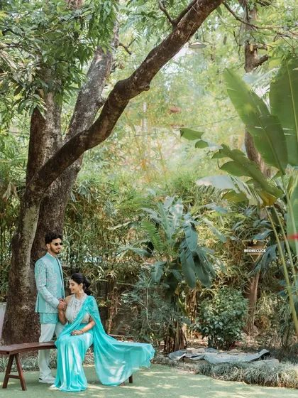 A serene portrait of the couple sitting together in a beautiful garden, a moment of calm amidst the Haldi festivities.
