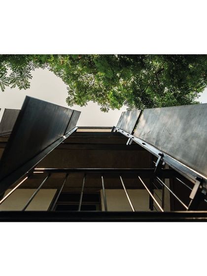 A worm's-eye view of the facade's concrete fins. This perspective emphasizes their slender profile and the rhythmic pattern they create, showcasing the technical precision of the ultra-high-performance concrete fabrication.