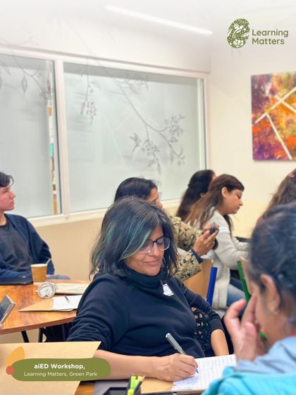 An educator diligently takes notes during a professional development session. We create an environment where learning is active and participants are empowered to absorb and apply new knowledge.