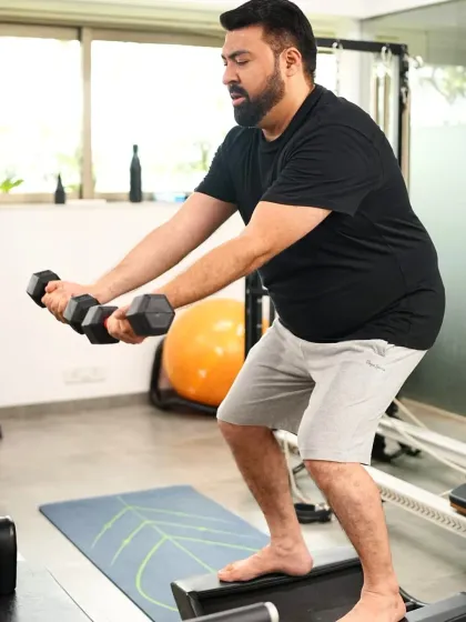 Here's a look at a couple training together at our studio. They are working on their strength and balance with dumbbells on an unstable surface, making their workout both challenging and fun.