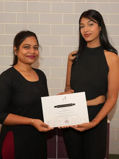 Another happy graduate receiving her certification. Each certificate represents weeks of hard work, dedication, and the start of an exciting journey in the makeup industry.