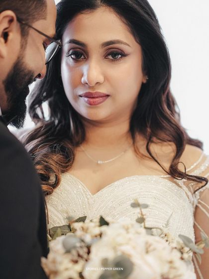 A poignant close-up of the bride, Amaya, looking at her groom. This intimate shot captures the deep love and emotion in her eyes, a key element of my cinematic style.