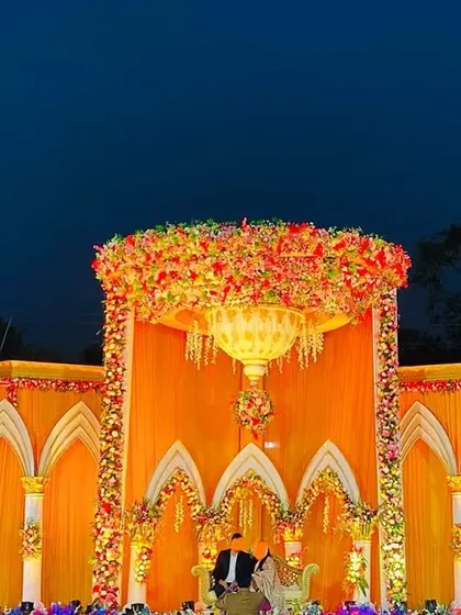 The palace stage against a twilight sky, with the internal lighting creating a warm and inviting glow.