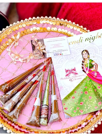 A traditional mehendi thali, beautifully arranged with fresh henna cones and decorative elements, ready for the ceremony.