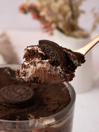 A spoonful of my Chocolate Oreo Trifle, showing the layers of chocolate mousse, cream, and chunks of Oreo cookies. A cookies and cream dream.