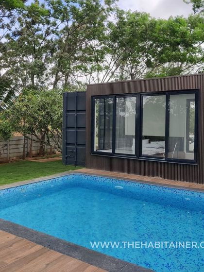 A stunning container home with a pool, perfect for a relaxing getaway.
