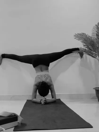 A demonstration of Samakonasana, the side splits, performed in an inversion against the wall. This is an intense hip opener that requires dedicated practice.