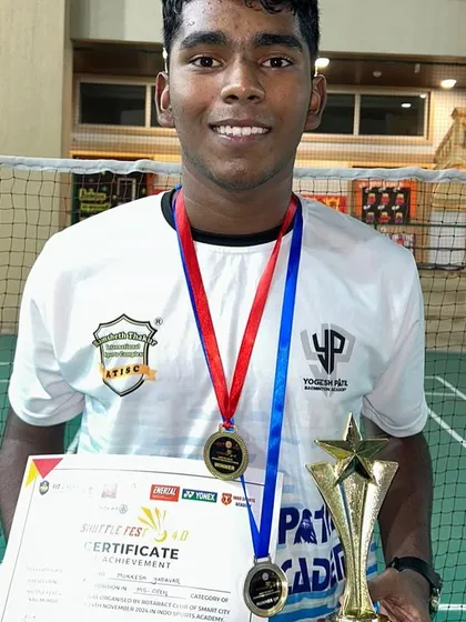 Mukkesh Yadavar proudly displaying his Men's Singles Winner trophy from SHUTTLE FEST 4.0. His dedication to the sport is an inspiration.