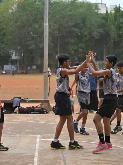 Sportsmanship in action. Young players high-five during a game, showing respect for their opponents and teammates.