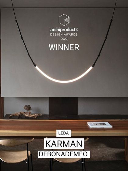 The Leda light is shown with its Archiproducts Design Award, a testament to its innovative and celebrated design.