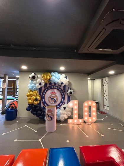Hala Madrid! A dream come true for a young football fan, this Real Madrid themed 10th birthday party featured the club's crest, colors, and football-themed balloons. The large light-up '10' made the birthday boy feel like a true champion.