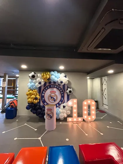 Hala Madrid! A dream come true for a young football fan, this Real Madrid themed 10th birthday party featured the club's crest, colors, and football-themed balloons. The large light-up '10' made the birthday boy feel like a true champion.