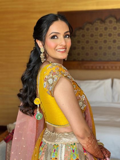 A beautiful side profile of the bride, showing off her romantic half-up hairstyle.