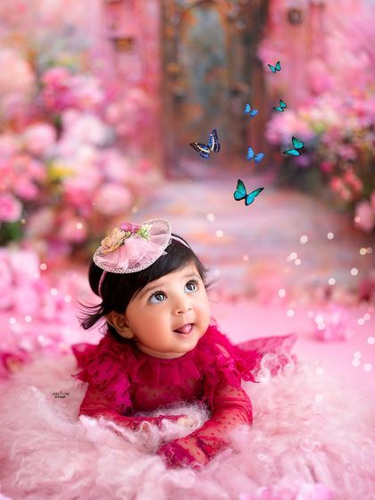 Lying on her tummy and looking up at the butterflies, a perfect pose for a six-month-old session.