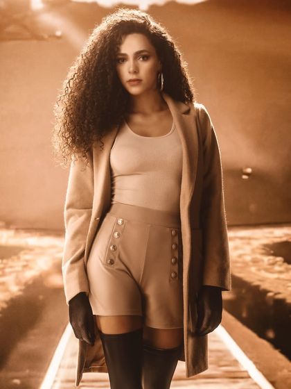 A sepia-toned, cinematic train track scene, created with projection. The warm lighting and atmospheric feel create a strong sense of narrative and journey.