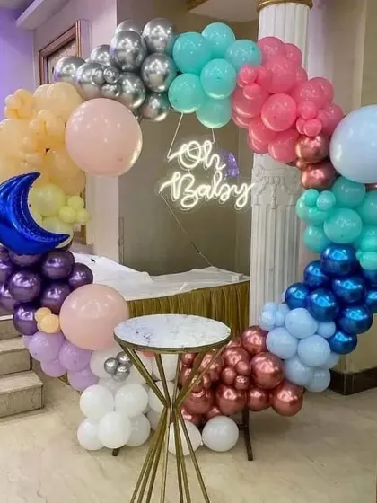 A unique and colorful "Oh Baby" balloon ring. The mix of chrome and pastel balloons with a crescent moon foil balloon makes for a very eye-catching decoration.
