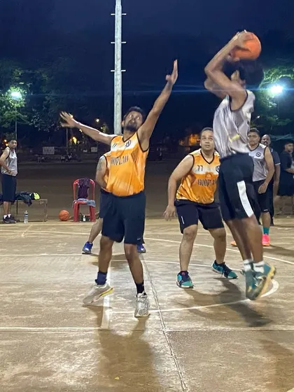 A player hangs in the air for a jump shot during a tense eliminator match. The athleticism is off the charts.
