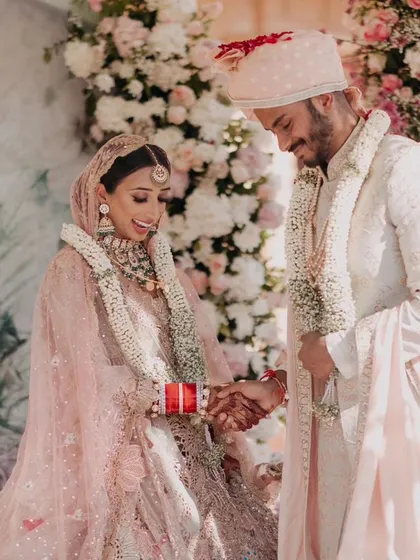 Priya and Nimlan sharing a lighthearted moment during their wedding ceremony. We focus on capturing these genuine smiles and interactions that tell the real story of the day.