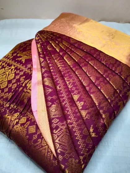 The intricate patterns on this wine-colored saree are highlighted by the sharp, clean pleats. I make sure the beauty of your saree is enhanced by my work.