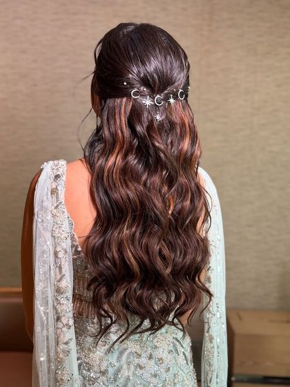 This angle shows the beautiful contrast of the dark, shiny hair and the sparkling silver accessories. The soft waves add dimension and movement.