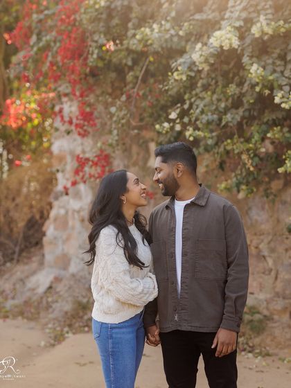 Finding a beautiful natural frame, like this wall of bougainvillea, adds so much to a portrait. It creates a soft, romantic backdrop for the couple's engagement photos in Delhi.