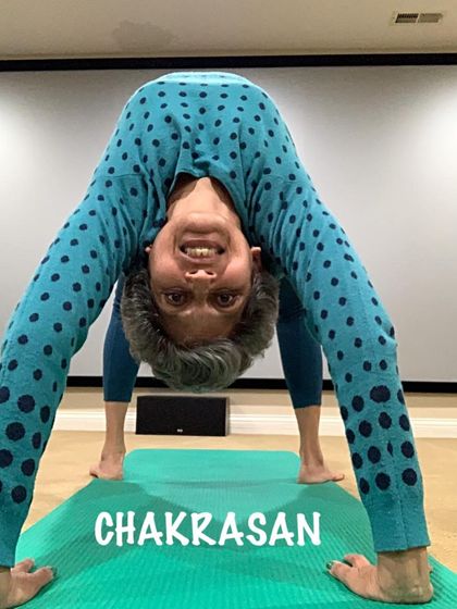 A playful variation of Chakrasana, looking through my legs. Yoga should be joyful and explorative.