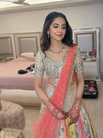 Another angle of Manvi's beautiful Roka look, showcasing the soft makeup and how it complements her colorful Abhinav Mishra lehenga.
