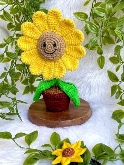 The full setup of the potted smiling sunflower on its stand, a perfect piece of crochet table decor.