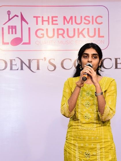 A Hindustani vocal student performs a classical piece at our concert. The stage is a place for all our students, regardless of their chosen musical style.