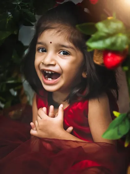 The pure, unscripted joy of a happy child. This candid shot of a toddler's laughter is a great example of the spontaneous moments I capture.