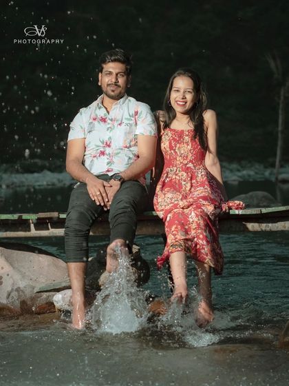 A fun, candid shot of a couple enjoying the river during their pre-wedding shoot, with the caption "Just go with the flow" perfectly matching the mood.