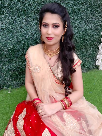 A glamorous look for a reception or sangeet. The client is wearing a red and gold lehenga, which I paired with a classic smokey eye, a bold red lip, and a voluminous wavy hairstyle.