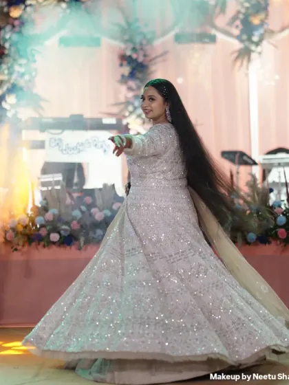 Twirling into the Sangeet night. This bride is wearing a spectacular glittering white lehenga, and her makeup is kept glamorous yet elegant to match the outfit's sparkle.