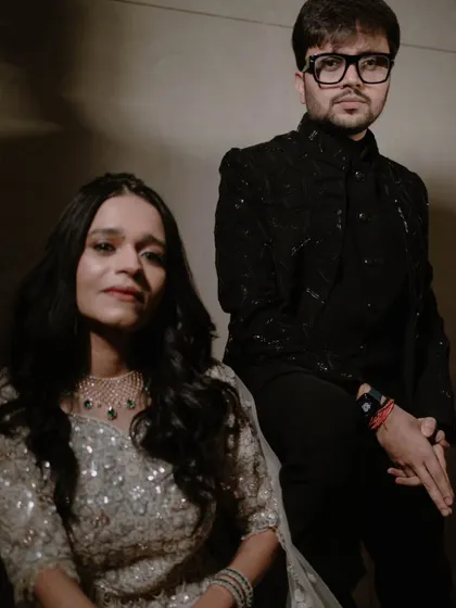 A stylish, moody portrait of the couple. I use lighting to create a dramatic, high-fashion look for sangeet or reception photos.