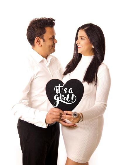 A joyful gender reveal! This is a fun and exciting way to incorporate an announcement into your maternity session, celebrating that "It's a girl!".