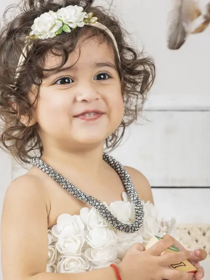 Sometimes, the most beautiful portraits are the simplest. This lifestyle session focused on her lovely curly hair and sweet smile, creating a timeless and classic baby photograph.