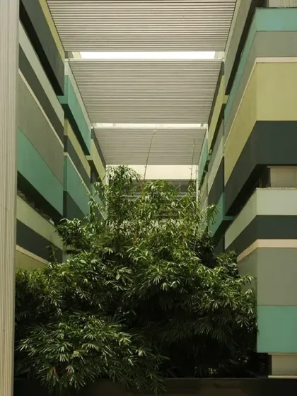 A central, tree-filled atrium cuts through the heart of the HP Campus in Bengaluru. This space acts as a social condenser, bringing employees together and providing a visual connection to nature from multiple floors.