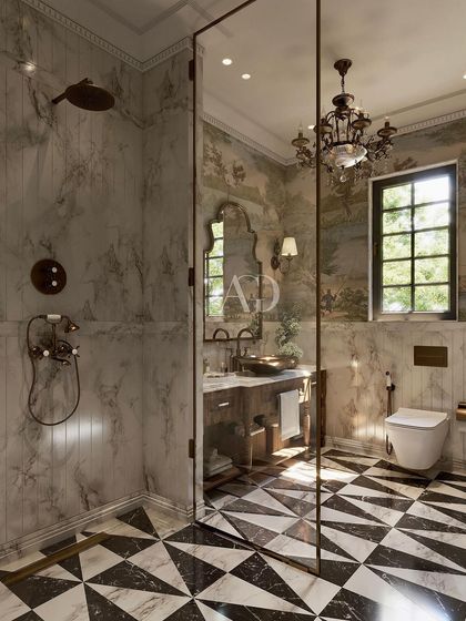The walk-in shower features marble walls and vintage-style brass fixtures, seamlessly blending with the rest of the Victorian-inspired design. The glass partition keeps the space feeling open and bright.