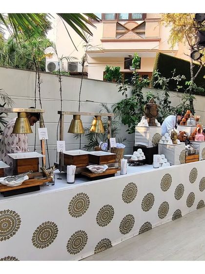 A stylish buffet setup for a winter high tea, with the table skirt featuring a modern block print design. We pay attention to every detail, including the linens and presentation, to match the event's aesthetic.