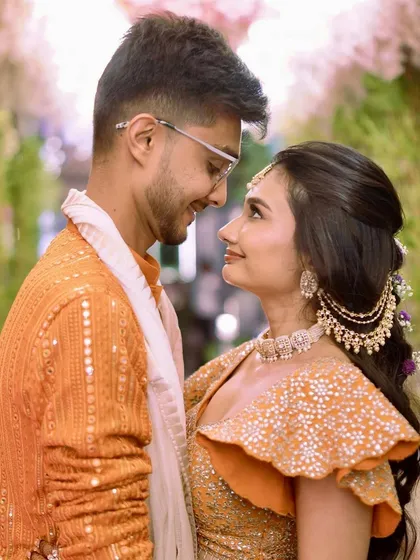 "And it was all yellow," or in this case, a beautiful orange. This couple's portrait captures the love and joy of the Haldi ceremony, with the bride looking absolutely radiant.