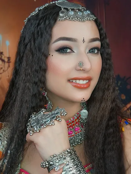 A close-up on the details of the Navratri look, showing the precise winged eyeliner, delicate bindi work, and the beautiful silver jewelry that completes the style.