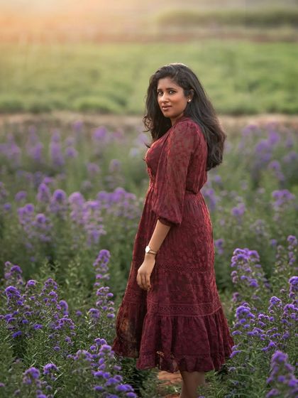 A duplicate of image 82, this outdoor portrait is all about atmosphere. The combination of the flower field, the warm light, and the subject's pose creates a truly magical and romantic image.