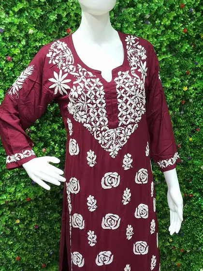 The delicate art of Lucknowi Chikankari is something I deeply admire. This maroon kurti, displayed on a mannequin, shows the beautiful, dense white thread embroidery that makes each piece a work of art. It’s crafted from soft, breathable fabric, ideal for elegant daywear.