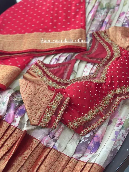 Another angle of the red half-saree materials, showcasing the different textures and patterns.