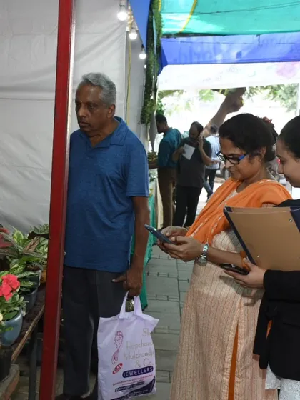 A customer at our Kala Ghoda festival stall, carefully selecting a new plant. We are always on hand to answer questions and help you make the perfect choice.