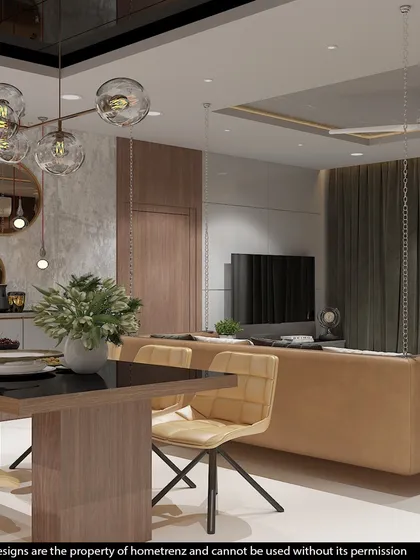 This view from the dining table looks towards the living area, showcasing the hanging bubble-style chandelier and the comfortable, modern furniture.