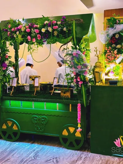 For a unique touch, I design themed food carts and counters like this one. This green, floral-adorned cart added a fresh and festive feel to the event, showing how I can customize setups to match your vision.