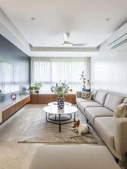 Even a compact apartment can feel spacious and luxurious. For this 950 sqft home, we used a light color palette, smart storage, and a long sectional sofa to create an open, inviting living area that even the family pet loves.